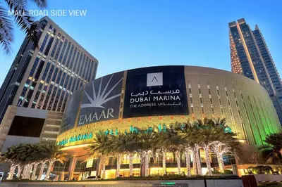 a building in a city with palm trees in front of it at JW Marriot Hotel Residence - Two bedroom Suite in Dubai