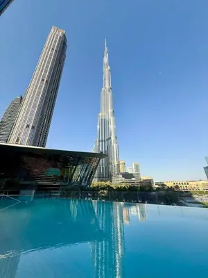 a view of a city with a tall building at 63rd High Floor - Full private Burj Khalifa and Fountain View - 2 Bedroom in Dubai