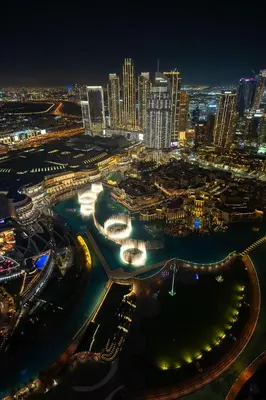 a city lit up at night with a city at 63rd High Floor - Full private Burj Khalifa and Fountain View - 2 Bedroom in Dubai