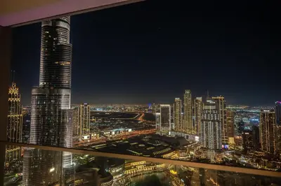 a view of a city skyline at night at 63rd High Floor - Full private Burj Khalifa and Fountain View - 2 Bedroom in Dubai