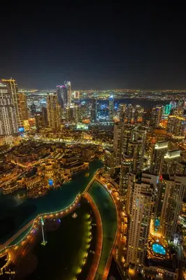 a view of a city at night with at 63rd High Floor - Full private Burj Khalifa and Fountain View - 2 Bedroom in Dubai