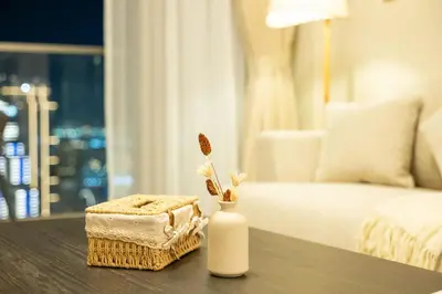a white vase with a box on a table in a bedroom at 63rd High Floor - Full private Burj Khalifa and Fountain View - 2 Bedroom in Dubai