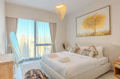 a bedroom with a large bed and a large window at 63rd High Floor - Full private Burj Khalifa and Fountain View - 2 Bedroom in Dubai