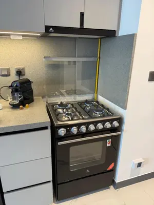 a kitchen with a black stove top oven at Cozy Dubai Studio I Prime Spot in Dubai