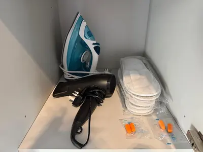 a hair dryer in a corner of a room at Cozy Dubai Studio I Prime Spot in Dubai