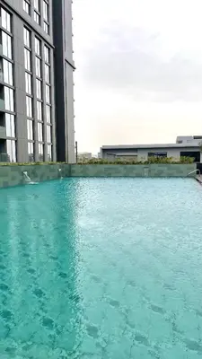 a large pool of blue water in front of buildings at Premium Chic Fully Furnished 1 BR in Sobha Hartland in Dubai