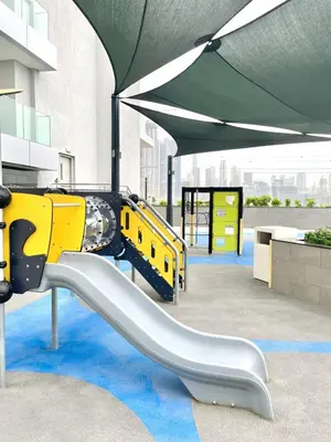 a playground with a slide in a building at Premium Chic Fully Furnished 1 BR in Sobha Hartland in Dubai