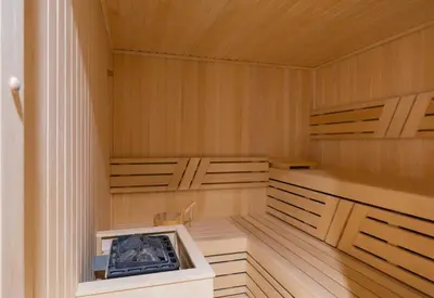 a sauna with wooden panels and a wooden floor at Premium Chic Fully Furnished 1 BR in Sobha Hartland in Dubai