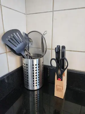 a metal bucket with utensils on a kitchen counter at Dubai Marina View, close to beach & metro in Dubai