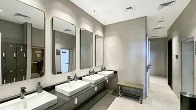 a bathroom with three sinks and three mirrors at Luxury 2BR Burj Khalifa and Canal View Pool Jacuzzi in Dubai