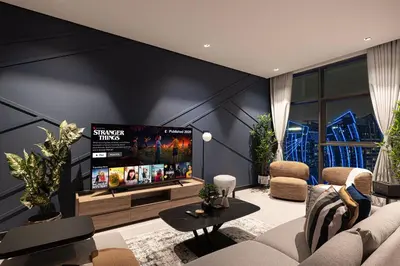 a living room with a large flat screen tv on a wall at Luxury 2BR Burj Khalifa and Canal View Pool Jacuzzi in Dubai