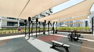 a gym with a row of exercise equipment in a building at Luxury 2BR Burj Khalifa and Canal View Pool Jacuzzi in Dubai