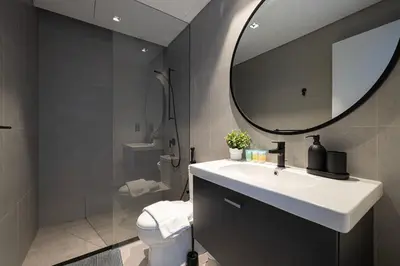 a bathroom with a sink and a mirror and a toilet at Luxury 2BR Burj Khalifa and Canal View Pool Jacuzzi in Dubai