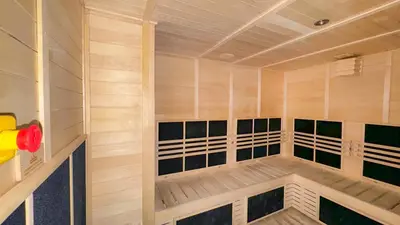 a sauna with wooden walls and floors and avisor at Luxury 2BR Burj Khalifa and Canal View Pool Jacuzzi in Dubai