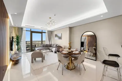 a living room with a table and chairs at PARAMOUNT MIDTOWN RESIDENCES - A Luxury 2 BR Apartment near BURJ KHALIFA and DUBAI MALL in Dubai