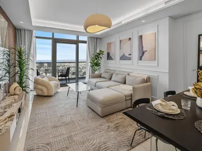 a living room with a couch and a table at PARAMOUNT MIDTOWN RESIDENCES - A Luxury 2 BR Apartment near BURJ KHALIFA and DUBAI MALL in Dubai