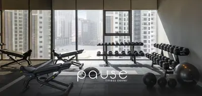 a gym with cardio equipment in a large window at PARAMOUNT MIDTOWN RESIDENCES - A Luxury 2 BR Apartment near BURJ KHALIFA and DUBAI MALL in Dubai