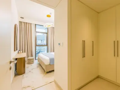 a hotel room with a bed and a bathroom at the 'Paris' Condo - Stylish 2Bd with Burj View in Dubai