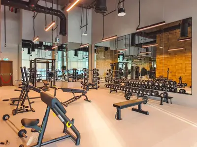 a gym with rows of treadmills and exercise equipment at the 'Paris' Condo - Stylish 2Bd with Burj View in Dubai