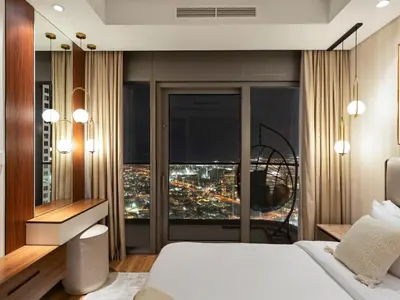 a bedroom with a large window with a city view at Burj View 3BDR with Rooftop Infinity Pool in Dubai