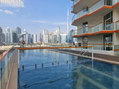 a swimming pool with a city skyline in the background at Cosy studio l close to Downtown in Dubai