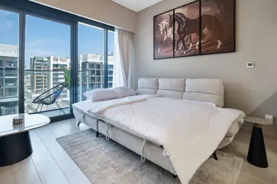 a bedroom with a large bed and a large window at Luxury 2BR in Meydan Near Downtown & Dubai Mall in Dubai