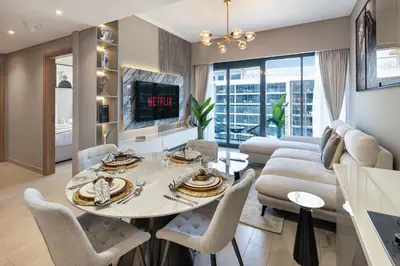a living room with a table and chairs and a couch at Luxury 2BR in Meydan Near Downtown & Dubai Mall in Dubai