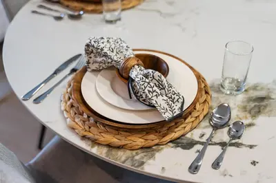 a table with a plate and a basket on a table at Luxury 2BR in Meydan Near Downtown & Dubai Mall in Dubai