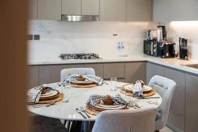 a kitchen with a table with plates of food on it at Luxury 2BR in Meydan Near Downtown & Dubai Mall in Dubai