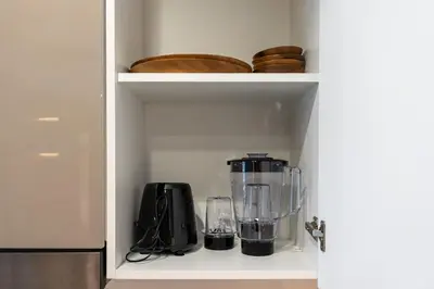 a kitchen shelf with a blender and other items at Luxury 2BR in Meydan Near Downtown & Dubai Mall in Dubai