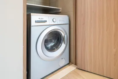 a white washer and dryer in a room at Luxury 2BR in Meydan Near Downtown & Dubai Mall in Dubai