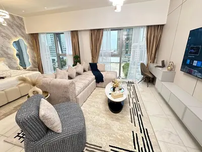 a living room with a couch and a table at Central Park Towers Royal suite DIFC Downtown in Dubai