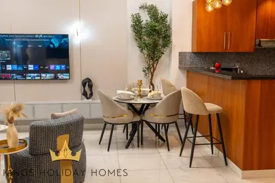 a dining room with a table and chairs at Central Park Towers Royal suite DIFC Downtown in Dubai
