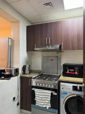 a kitchen with a stove and a washing machine at Apartment in dubai in Dubai
