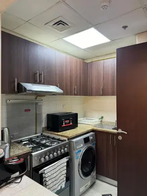 a kitchen with a stove and a washing machine at Apartment in dubai in Dubai