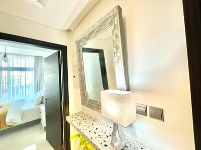 a mirror on a wall next to a bedroom at Amazing 3BHK Townhouse in Damac Hills 2 upto 10PLL in Dubai