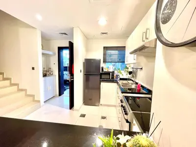 a kitchen with a refrigerator and a counter top at Amazing 3BHK Townhouse in Damac Hills 2 upto 10PLL in Dubai