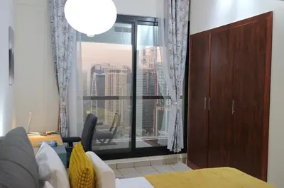 a bedroom with a large window with a city view at Cosy 1 bed in Dubai Marina in Dubai