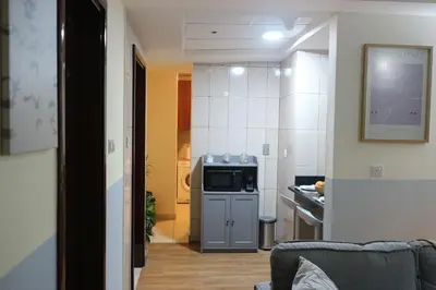 a small kitchen with a microwave and a stove at Cosy 1 bed in Dubai Marina in Dubai