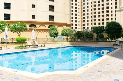 a large swimming pool with buildings in the background at 1BR Apartment JBR in Dubai