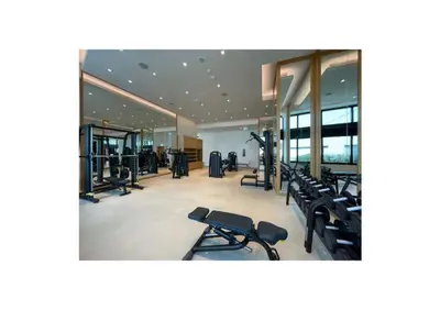 a gym with treadmills and elliptical machines at 1BR Apartment JBR in Dubai