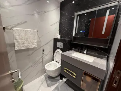 a bathroom with a toilet and a sink and a mirror at 1BR Apartment JBR in Dubai