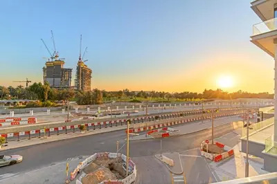 a view of a highway with a city in the background at Elegant 1BR Apt with Balcony Views of Burj Khalifa & Dubai Canal in Dubai