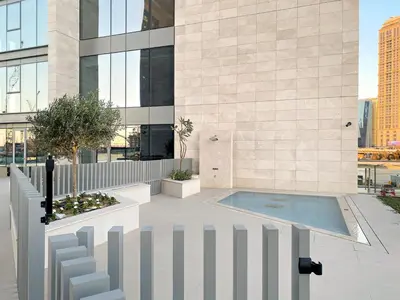 a building with a swimming pool in front of a building at Elegant 1BR Apt with Balcony Views of Burj Khalifa & Dubai Canal in Dubai