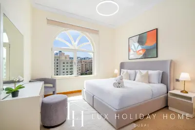 a bedroom with a bed and a window at LUX The Shoreline Palm Island Skyline Suite 2 in Dubai