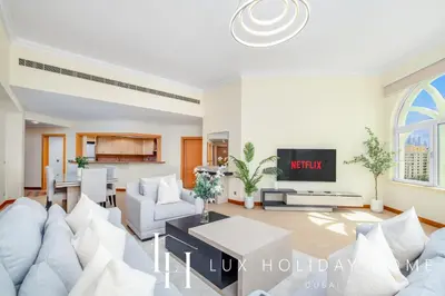 a living room with white furniture and a large window at LUX The Shoreline Palm Island Skyline Suite 2 in Dubai