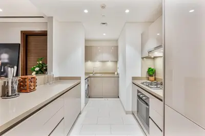 a kitchen with white cabinets and a sink at Luxury 2BR in Sobha Hartland in Dubai