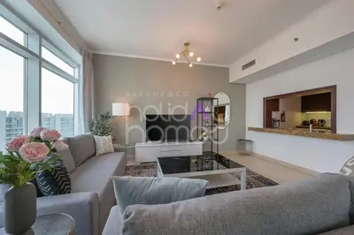 a living room with a couch and a table at Modern 1BR in Burj Views Tower Downtown in Dubai