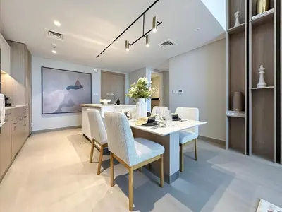 a kitchen and dining room with a table and chairs at Trophy-Aesthetic Apartment w Skyline and Dubai in Dubai