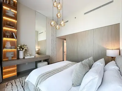 a bedroom with a large white bed and a desk at Trophy-Aesthetic Apartment w Skyline and Dubai in Dubai